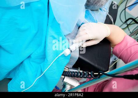 Syringe with anesthesia in the doctor's hand. Administering an anesthetic to a patient during surgery. Stock Photo