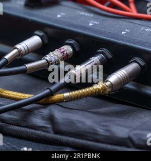 Audio jacks are plugged into a guitar synthesizer or processor Stock Photo