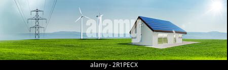 Wind turbines and solar cells on a house roof in a green meadow with power line Stock Photo
