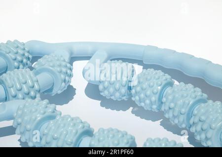 Fitness roller massager for manual deep tissue massage, relaxation, sore muscle relief. Blue plastic device for manual leg massage and self-care isola Stock Photo