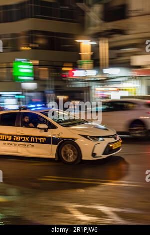Security/Police car moving quickly through the streets of Tel Aviv Israel December 2022 Stock Photo