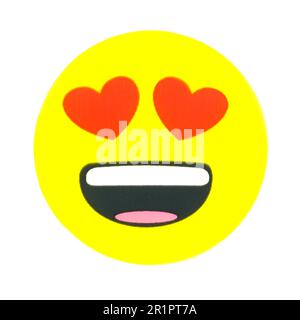 Smiling face with heart eyes emoticon Stock Photo