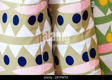 Three cushions or pillows with patterned covers Stock Photo