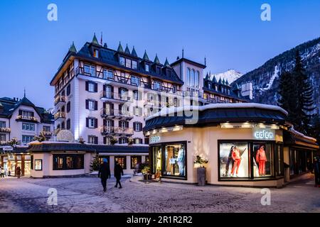 People in the Bahnhofstrasse in front of the Hotel Mont Chervin Palace, Zermatt, Valais, Switzerland Stock Photo