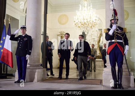 Paris, France. 15th May, 2023. French President Emmanuel Macron, left, escorts Ukrainian President Volodymyr Zelenskyy, right, to meetings at the Elysee Palace, May 14, 2023 in Paris, France. Credit: Pool Photo/Ukrainian Presidential Press Office/Alamy Live News Stock Photo
