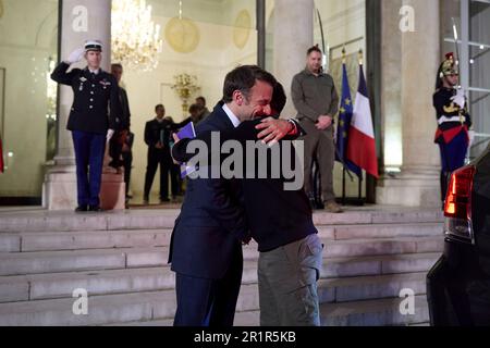 Paris, France. 15th May, 2023. French President Emmanuel Macron, left, embraces Ukrainian President Volodymyr Zelenskyy, right, as he departs following meetings at the Elysee Palace, May 14, 2023 in Paris, France. Credit: Pool Photo/Ukrainian Presidential Press Office/Alamy Live News Stock Photo