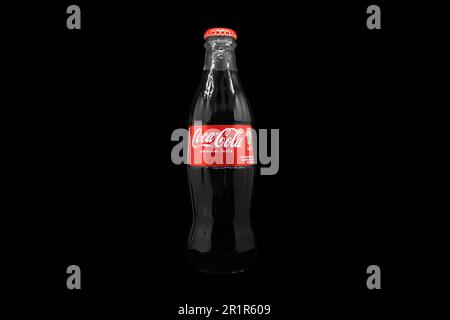 Yerevan, Armenia, May 10, 2023: Coca Cola logo on a cork cap. Black glass bottle of Coca-Cola sparkling water. Classic company logo. Bottle of Cola st Stock Photo