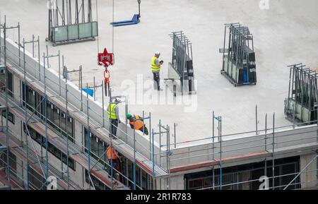 Glazier installing windows on a commercial building. Stock Photo