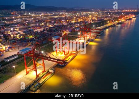 NANJING, CHINA - MAY 15, 2023 - Cargo ships load containers at the Longtan Container Terminal of Nanjing Port at night in Nanjing, Jiangsu province, C Stock Photo