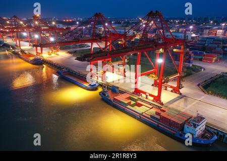 NANJING, CHINA - MAY 15, 2023 - Cargo ships load containers at the Longtan Container Terminal of Nanjing Port at night in Nanjing, Jiangsu province, C Stock Photo