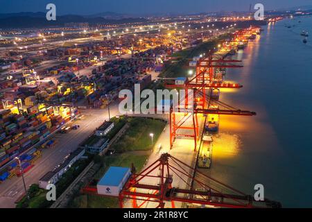 NANJING, CHINA - MAY 15, 2023 - Cargo ships load containers at the Longtan Container Terminal of Nanjing Port at night in Nanjing, Jiangsu province, C Stock Photo