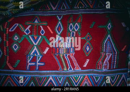 A vibrant, multi-hued rug with intricate geometric shapes and designs Stock Photo