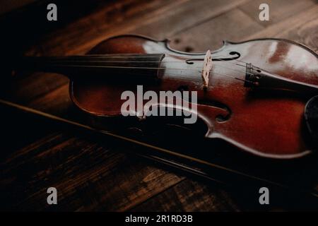Close-up of a violin on a wooden table Stock Photo