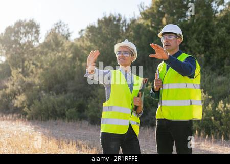 Two professional engineers working together on a project in the field. Stock Photo