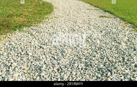 Curvy gravel path in the morning sunlight Stock Photo