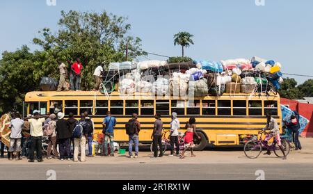 A mattress being loaded onto a crowded bus Morrumbala Mozambique. Stock Photo