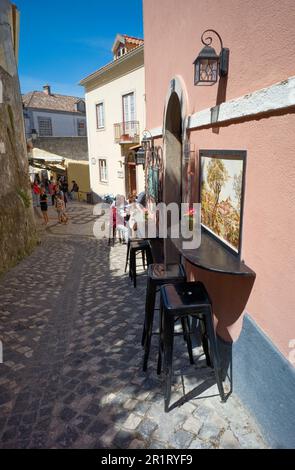 In the narrow streets of Sintra space is at a premium as shown by these bar tables fixed to walls Stock Photo