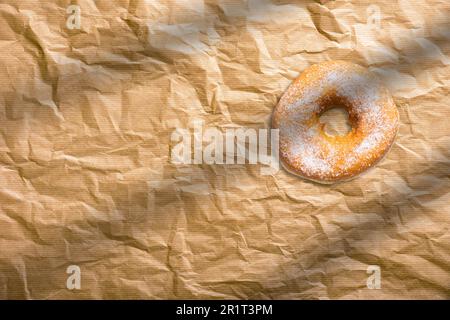 Fresh homemade donuts with sugar powder on baking paper. American bakery concept. Stock Photo