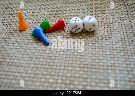 White dice and four figures for table games. Stock Photo
