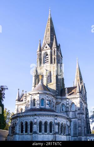 The tall Gothic spire of an Anglican church in Cork, Ireland. Neo-Gothic Christian religious architecture. Cathedral Church of St Fin Barre, Cork - On Stock Photo