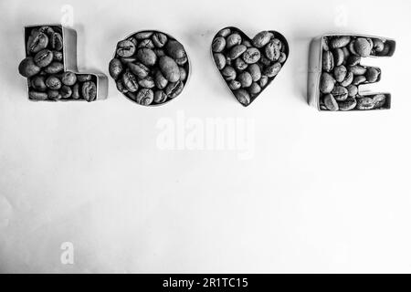 Beautiful texture with the word love for valentine's day inscription made from roasted selected brown natural aromatic Arabica coffee beans, robusta C Stock Photo