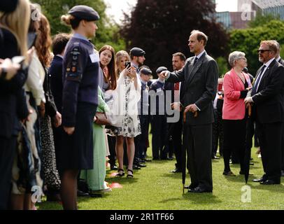 The Duke of Edinburgh talks to guests as he hosts young people from The Duke of Edinburgh's Award scheme in the garden of Buckingham Palace, London. Picture date: Monday May 15, 2023. Stock Photo