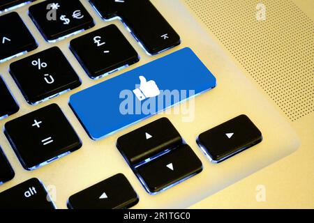 Close up on a blue key with a white thumb up on it. Stock Photo