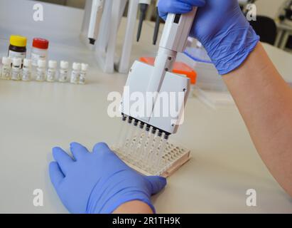 Glass bottles in production in the tray of an automatic liquid dispenser, a line for filling medicines against bacteria and viruses, antibiotics and v Stock Photo