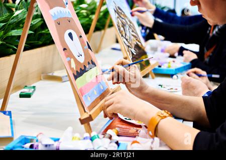 Woman artist paints a picture Stock Photo