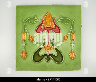 Antique 1900s Minton Art Nouveau amber and red tulip pottery tile Stock Photo