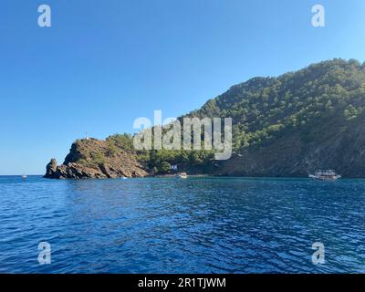 Big beautiful tropical paradise island with mountains, plants and trees green and blue salty warm sea. Stock Photo