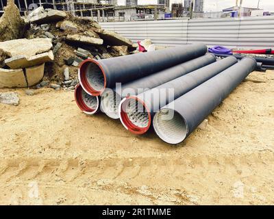 Concrete blocks and plastic pvc sewage pipe on palette on building