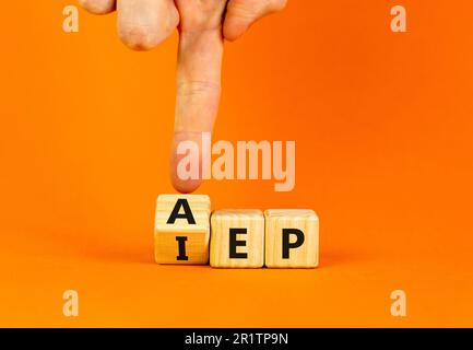 AEP or IEP symbol. Concept words AEP annual enrollment period IEP initial enrollment period. Doctor hand. Beautiful orange background. Medical annual Stock Photo