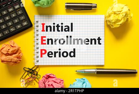 IEP symbol. Concept words IEP Initial enrollment period on beautiful white note. Beautiful yellow table yellow background. Calculator. Medical and IEP Stock Photo