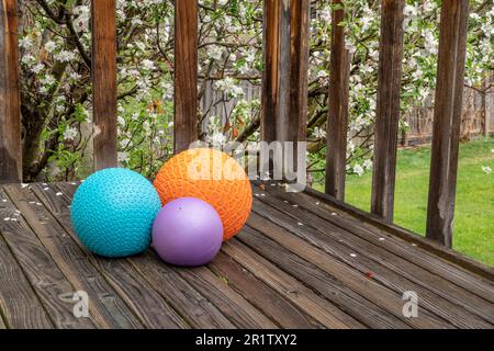 heavy slam balls filled with sand on a backyard deck, exercise and functional fitness concept Stock Photo