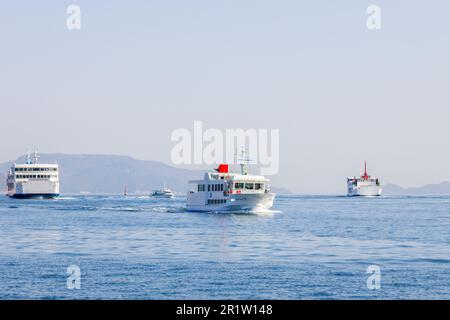 Takamatsu, Japan - March 29, 2023: Ferry boat crossing the Seto Inland Sea from Takamatsu to Naoshima Island Stock Photo