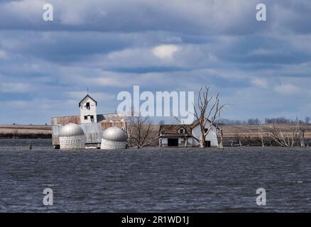 Farm buildings partially submerged in a lake near Webster, South Dakota. Stock Photo