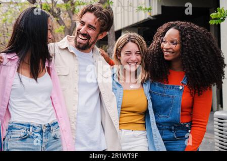 Group of multiracial happy friends smiling and laughing together on a social meeting. United cheerful young multiethnic people having fun. Multicultural international community hugging on vacation. High quality photo Stock Photo