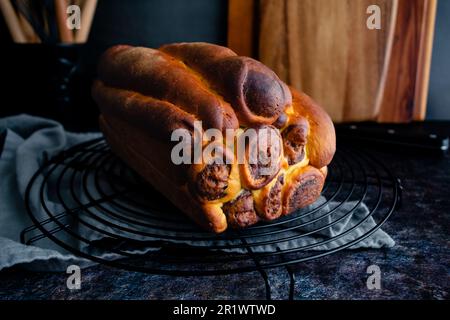 Loaf of Uncut Leopard Milk Bread on a Wire Rack: A loaf of Japanese milk bread with leopard or giraffe spots colored with cocoa powder Stock Photo