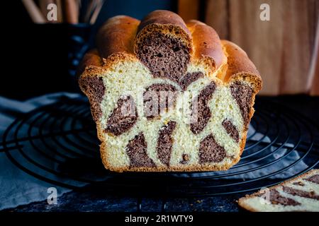 Sliced Loaf of Leopard Milk Bread on a Cooking Rack : A loaf of Japanese milk bread with leopard or giraffe spots colored with cocoa powder Stock Photo
