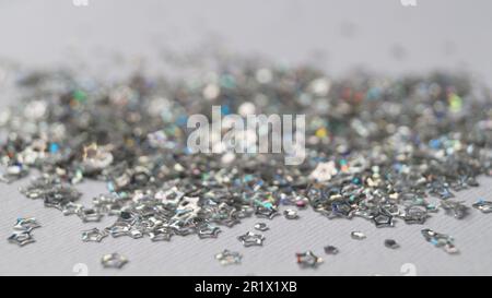 Pile of silver star shaped sequins on white background, closeup Stock Photo