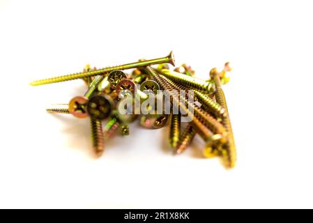 Long gold screws isolated on white backgound Stock Photo