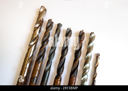 Close up of assorted drill bits of various sizes isolated on white background. Stock Photo
