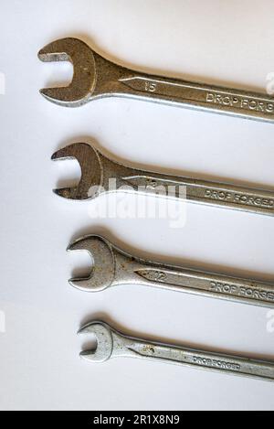 Set of four silver wrenches or spanners of different sizes, isolated on white background.  Stock Photo