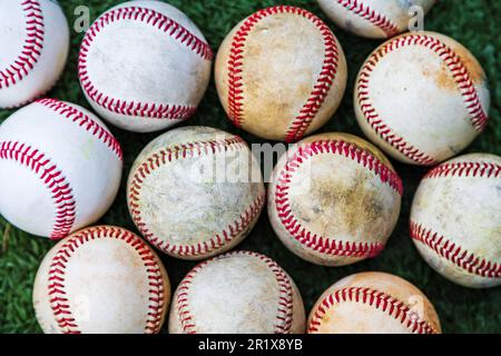 Collection of used baseballs on the ground for sports background Stock Photo