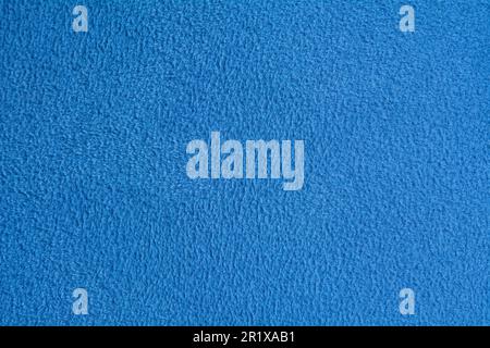 Close-up of a blue-textured, patterned fabric. The fabric has a rich pattern and texture. The fabric's brilliant blue color pattern and texture draw Stock Photo