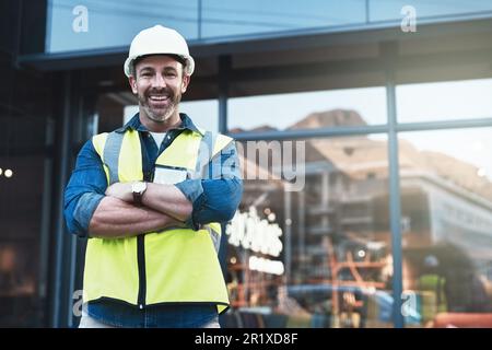Engineer, portrait of man architect standing in front of construction site and arms crossed. Industrial or architecture, project or management and Stock Photo