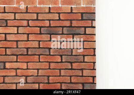 Decorative bricks with tile leveling system on white wall Stock Photo