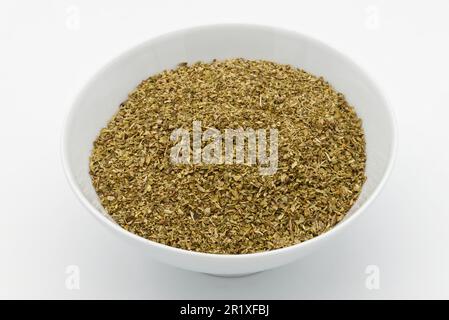 A bowl of dried oregano isolated on white background. Stock Photo