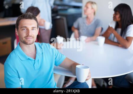 Taking a break in the cafeteria. a group of coworkers sitting in the cafeteria. Stock Photo